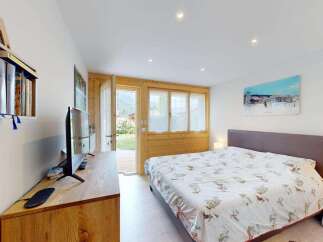 Experience cozy living in this charming bedroom featuring a comfortable bed with a nature-inspired duvet cover.
