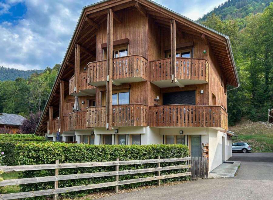 Experience alpine living in this charming wooden chalet, featuring multiple balconies with scenic mountain views.