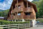 Experience alpine living in this charming wooden chalet, featuring multiple balconies with scenic mountain views.