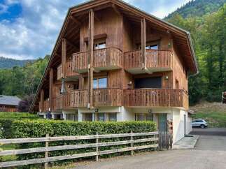 Experience alpine living in this charming wooden chalet, featuring multiple balconies with scenic mountain views.