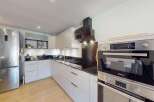 This modern kitchen boasts a sleek, integrated design with ample storage and high-end appliances.