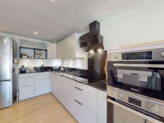 This modern kitchen boasts a sleek, integrated design with ample storage and high-end appliances.