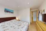 This cozy bedroom features a comfortable bed with a unique ski-themed duvet cover, perfect for a winter getaway.