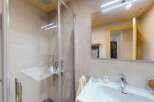 Experience modern comfort in this beautifully appointed bathroom, featuring a sleek glass-enclosed shower and a spacious vanity with a contemporary faucet.