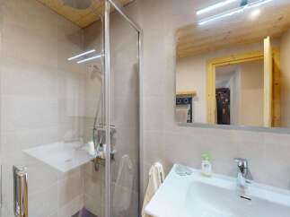 Experience modern comfort in this beautifully appointed bathroom, featuring a sleek glass-enclosed shower and a spacious vanity with a contemporary faucet.