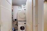 Discover a functional laundry area featuring a stacked washer and dryer, perfect for maximizing space.