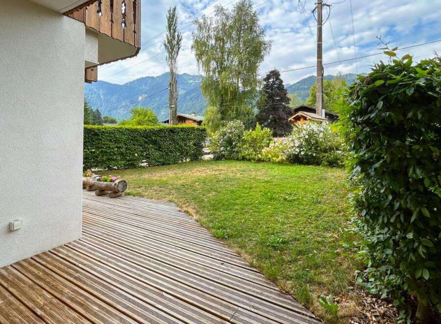Enjoy the serene mountain views from this charming property, featuring a spacious wooden deck perfect for outdoor relaxation.