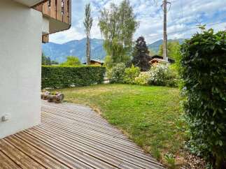 Enjoy the serene mountain views from this charming property, featuring a spacious wooden deck perfect for outdoor relaxation.