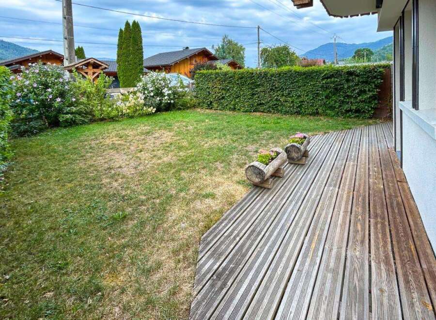 Enjoy outdoor living on this charming wooden deck, perfect for relaxing or entertaining.