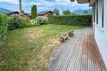 Enjoy outdoor living on this charming wooden deck, perfect for relaxing or entertaining.