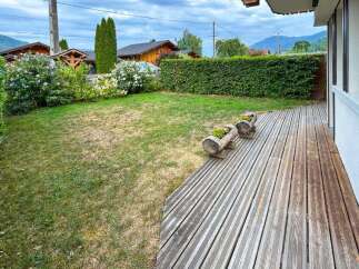 Enjoy outdoor living on this charming wooden deck, perfect for relaxing or entertaining.