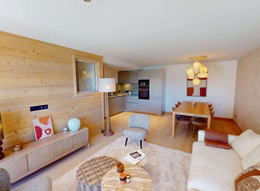 Experience modern alpine living in this beautifully appointed apartment, featuring a spacious open-plan living, dining, and kitchen area.