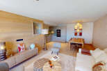 Experience modern alpine living in this beautifully appointed apartment, featuring a spacious open-plan living, dining, and kitchen area.