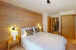 Experience rustic charm in this cozy bedroom featuring a stunning wooden accent wall that adds warmth and character.
