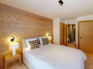 Experience rustic charm in this cozy bedroom featuring a stunning wooden accent wall that adds warmth and character.