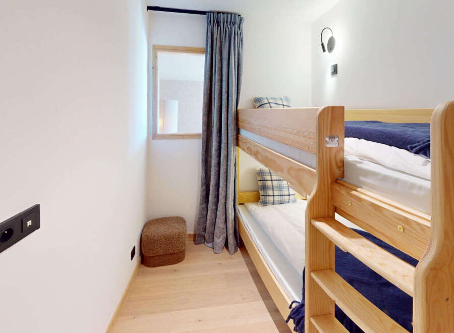 This cozy room features a space-saving bunk bed, perfect for families or accommodating guests.