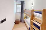This cozy room features a space-saving bunk bed, perfect for families or accommodating guests.