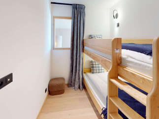 This cozy room features a space-saving bunk bed, perfect for families or accommodating guests.