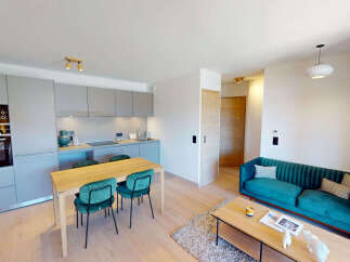 Experience modern living in this open-concept apartment featuring a sleek, integrated kitchen with high-end appliances and ample cabinet space.