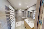 Experience modern comfort in this beautifully appointed bathroom, featuring a spacious glass-enclosed shower with sleek tile work and a convenient built-in bench.
