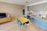 Experience modern living in this beautifully appointed apartment, featuring a sleek, integrated kitchen with ample cabinet space and a stylish dining area perfect for intimate meals.