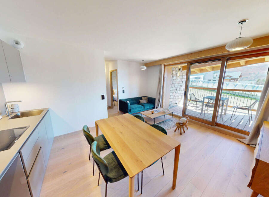 Experience modern living in this beautifully appointed apartment, featuring a sleek, integrated kitchen with a stainless steel sink and induction hob.