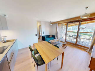Experience modern living in this beautifully appointed apartment, featuring a sleek, integrated kitchen with a stainless steel sink and induction hob.