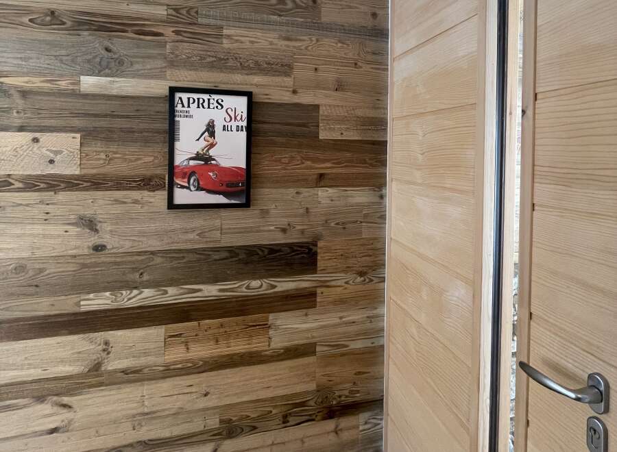 Experience rustic charm with this beautifully paneled wooden wall, featuring a unique distressed finish that adds character and warmth to any space.