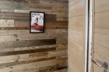 Experience rustic charm with this beautifully paneled wooden wall, featuring a unique distressed finish that adds character and warmth to any space.