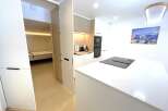 Discover modern living in this beautifully appointed kitchen featuring sleek white countertops and integrated appliances.