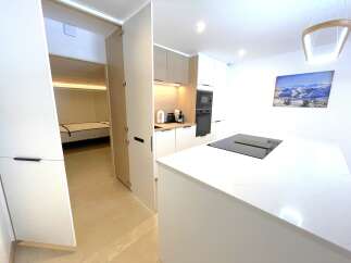 Discover modern living in this beautifully appointed kitchen featuring sleek white countertops and integrated appliances.