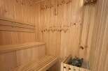 Experience ultimate relaxation in this beautifully crafted wooden sauna, featuring comfortable tiered seating perfect for unwinding.