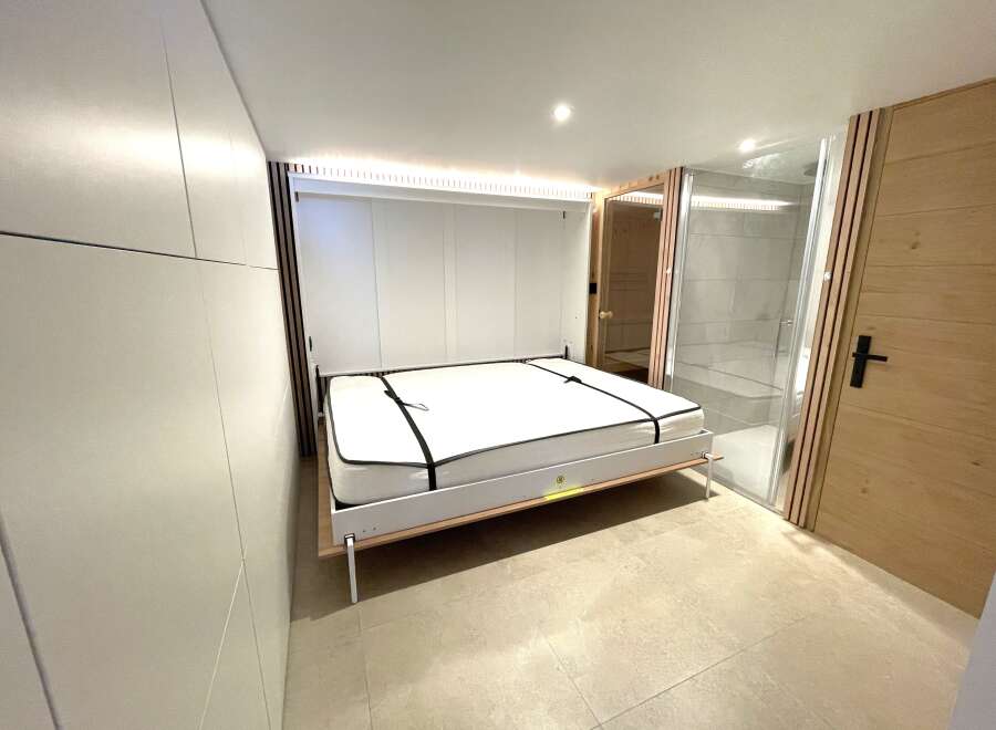 Discover modern living with this innovative Murphy bed setup, perfect for maximizing space in any room.