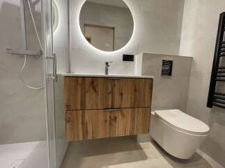 Experience modern luxury in this stunning bathroom featuring a sleek vanity with ample storage and a floating design.