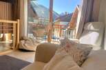 Experience breathtaking mountain views from this cozy living space, featuring a comfortable armchair and a plush beanbag chair perfect for relaxation.