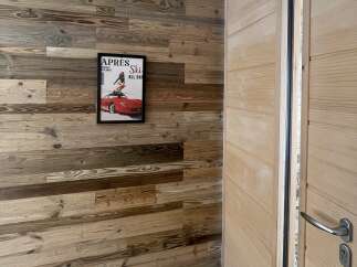 Experience rustic charm with this beautifully paneled wooden wall, featuring a unique distressed finish that adds character and warmth to any space.