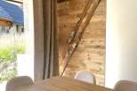 Experience rustic charm with this beautifully decorated interior featuring a wooden accent wall adorned with vintage skis.