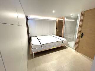 Discover modern living with this innovative Murphy bed setup, perfect for maximizing space in any room.