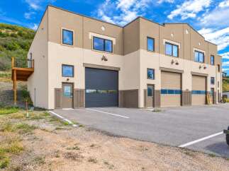 Discover this modern commercial property featuring multiple garage bays and individual entrances, perfect for businesses seeking versatile space.