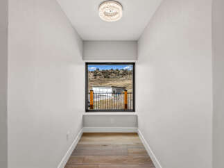Experience breathtaking views from this unique hallway, featuring a large window that frames the picturesque landscape.