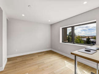 This modern office space features a large window offering scenic views and ample natural light.