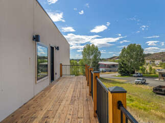 Enjoy the outdoors from this spacious wooden deck, perfect for entertaining or relaxing with a view.
