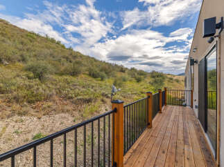 Enjoy the stunning natural surroundings from this beautiful wooden deck, perfect for outdoor living.