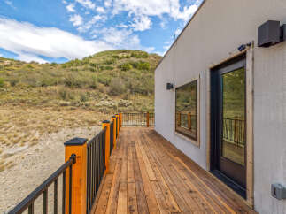 Enjoy breathtaking mountain views from this expansive wooden deck, perfect for outdoor entertaining or quiet relaxation.