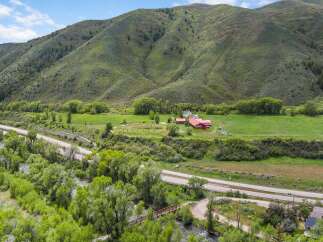 Discover this stunning property nestled in a picturesque valley, offering a serene retreat with a charming farmstead and a babbling river.