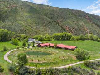 Discover this stunning ranch property nestled against a majestic mountain backdrop.