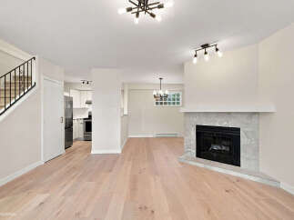 Discover modern living in this beautifully renovated home featuring a sleek fireplace and a bright, open-concept living space.