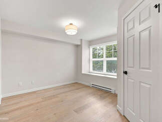 Step into this bright and airy bedroom, featuring a large window that floods the space with natural light.