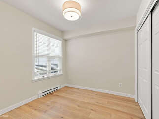 This bright and airy room features a large window with blinds, allowing natural light to fill the space.