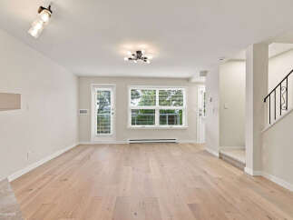 Step into this bright and airy living space featuring gleaming hardwood floors and abundant natural light.